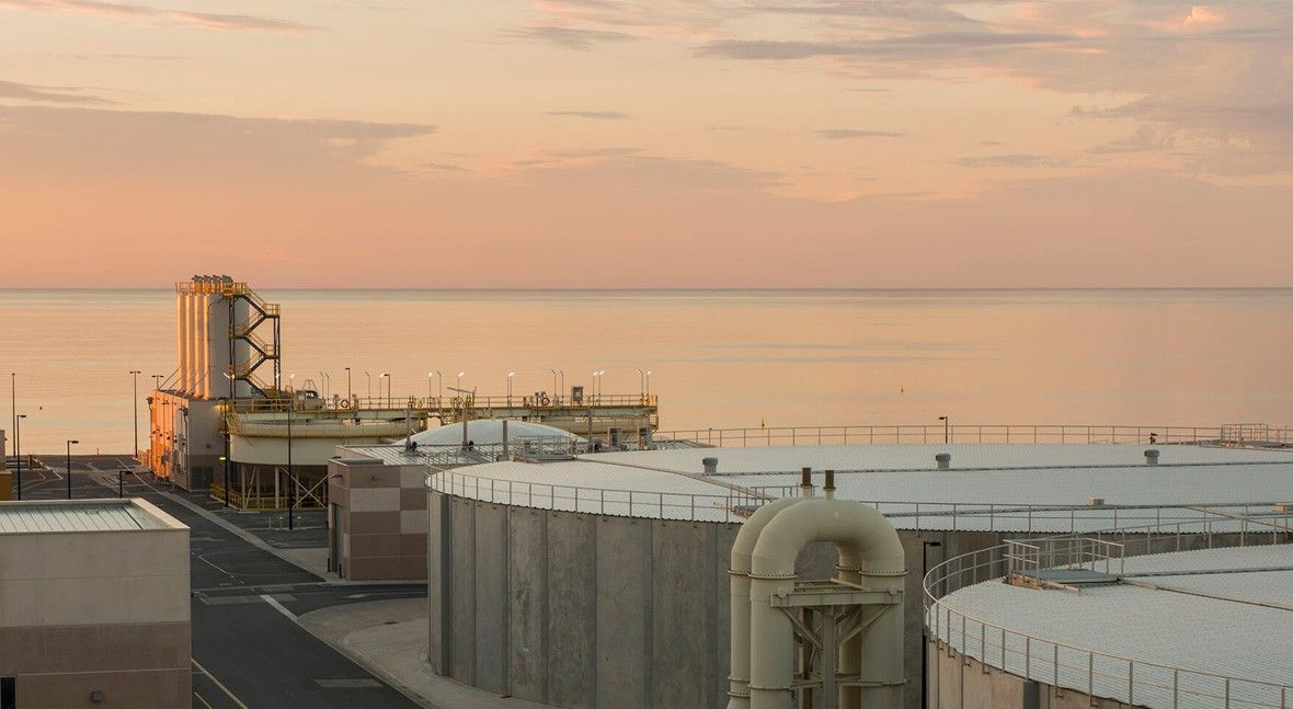 A large, modern desalination plant on the coast of Spain, a key solution to the water scarcity crisis.